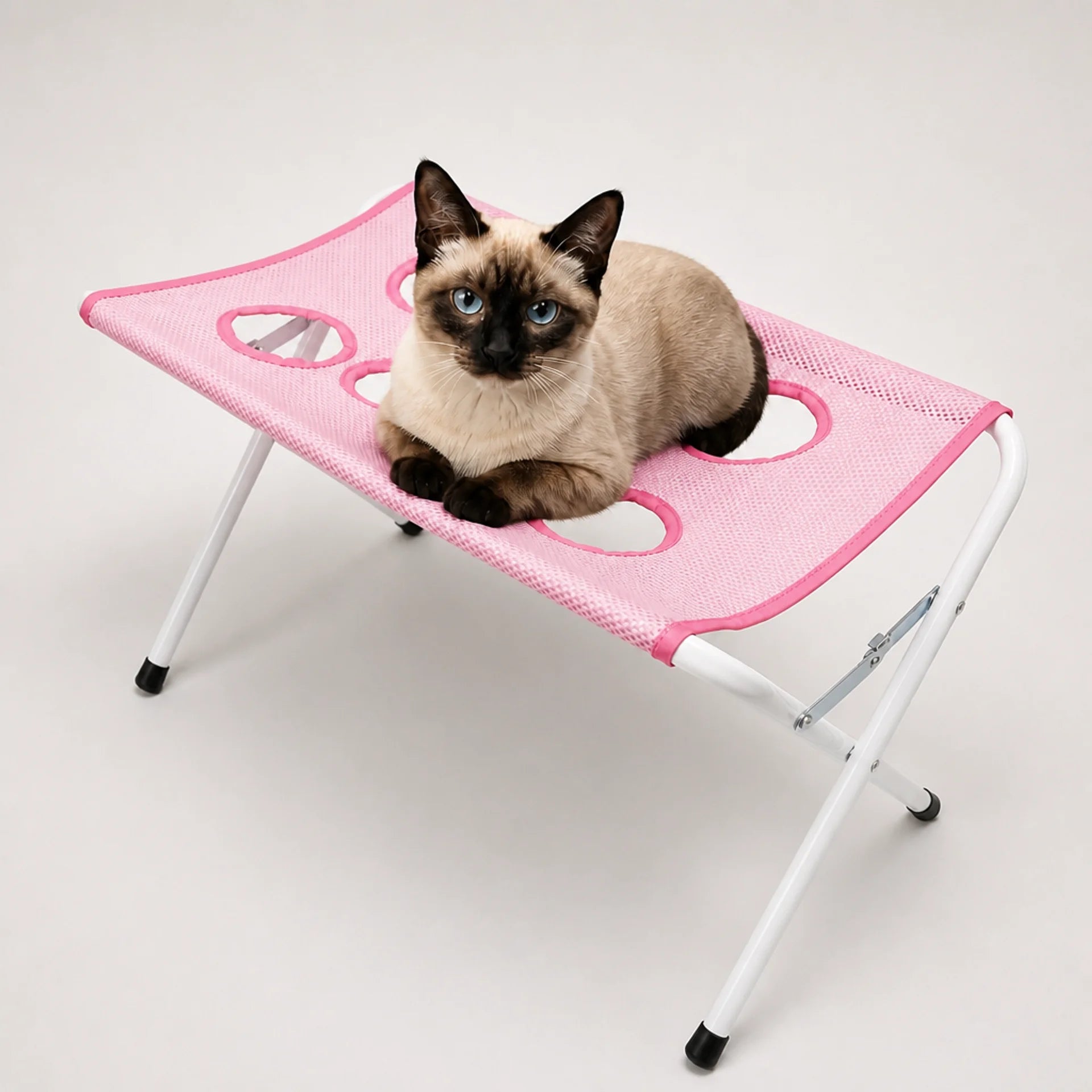 Purrenza Grooming Stand in pink with a cat resting on the mesh surface